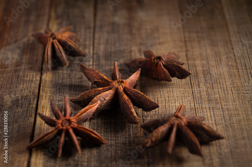 STAR ANISE ON WOODEN BACKGROUND, MACRO PHOTOGRAPHY OF GARAM MASALA ON WOODEN TEXTURE BACKGROUND, 
