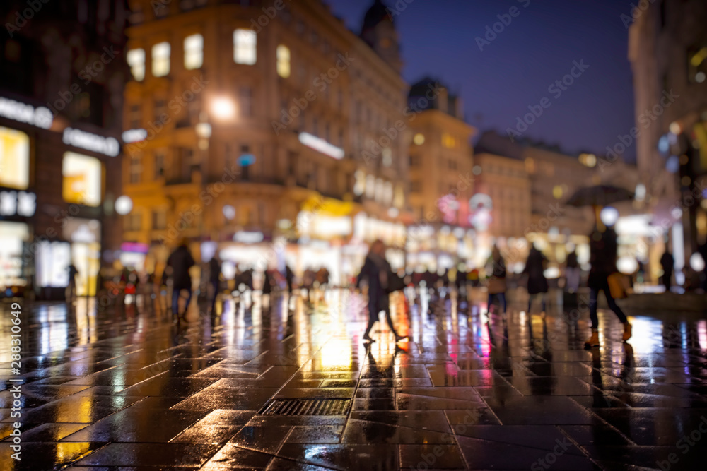 crowd of people walking on night streets in the city