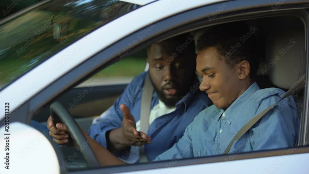 Auto instructor scolding young driver chatting smartphone lesson, safety rules Auto instructor scolding young driver chatting smartphone lesson, safety rules