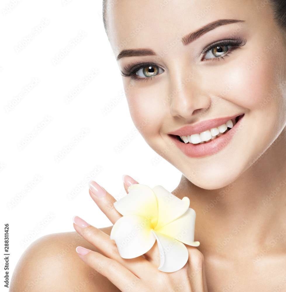 Beautiful smiling face of young woman with flower Beautiful smiling face of young woman with flower