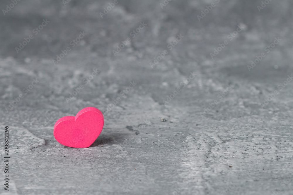 Fototapeta premium pink heart and concrete background. Love symbol and copy space, Valentines Day background