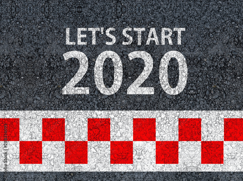 happy new year 2020. lets start 2020 and racing start line written on an asphalt road happy new year 2020. lets start 2020 and racing start line written on an asphalt road