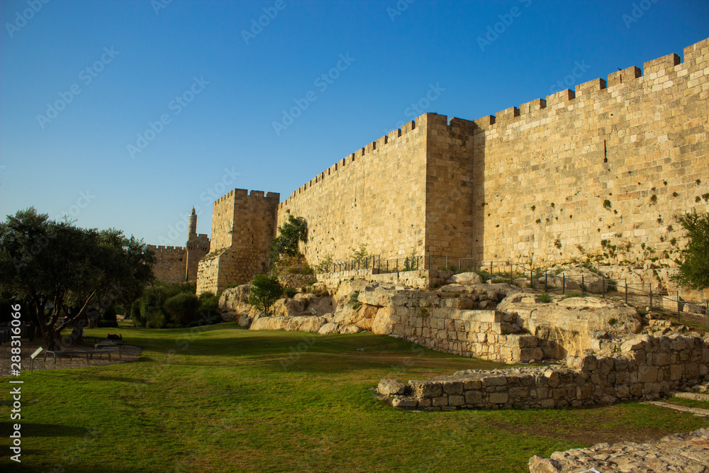 Jerusalem old city protection walls ancient stone architecture UNESCO world famous heritage site for many tourist and sightseeing 