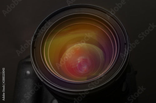 Lens of professional camera on black background, closeup