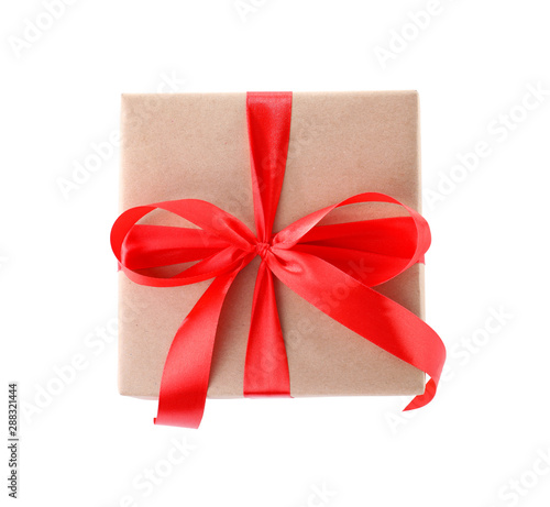 Christmas gift box decorated with ribbon bow on white background, top view