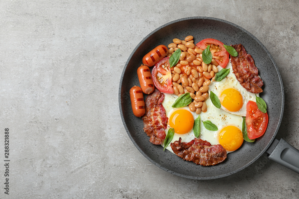 Delicious breakfast with fried eggs served on grey table, top view. Space for text Delicious breakfast with fried eggs served on grey table, top view. Space for text