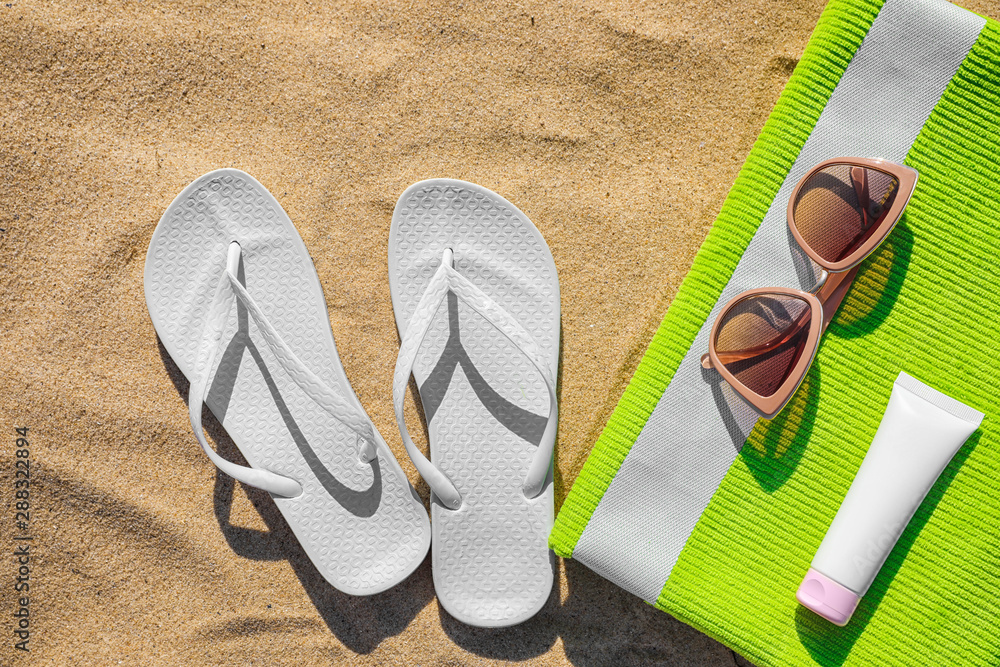 Naklejka premium Flat lay composition with different beach accessories on sand