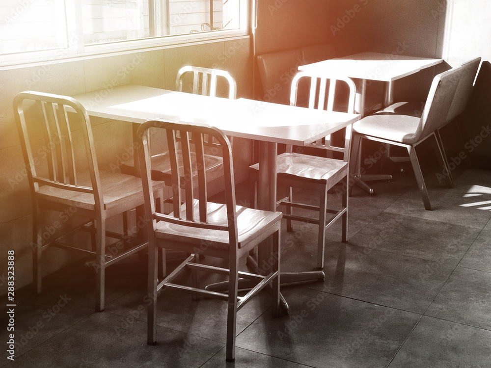 Chairs and table in the empty restaurant.The sun shines into the dining room. Sunlight hits objects