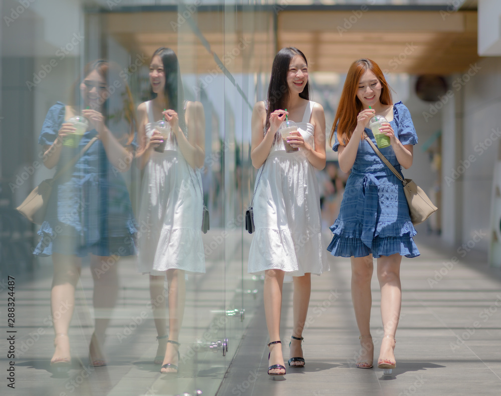 student girls woman walking in the building with holding cup of beverage in hand student girls woman walking in the building with holding cup of beverage in hand