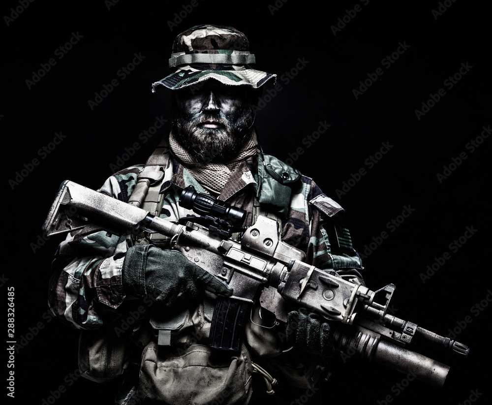 Commando soldier in battle ammunition, armed rifle Commando soldier in battle ammunition, armed rifle