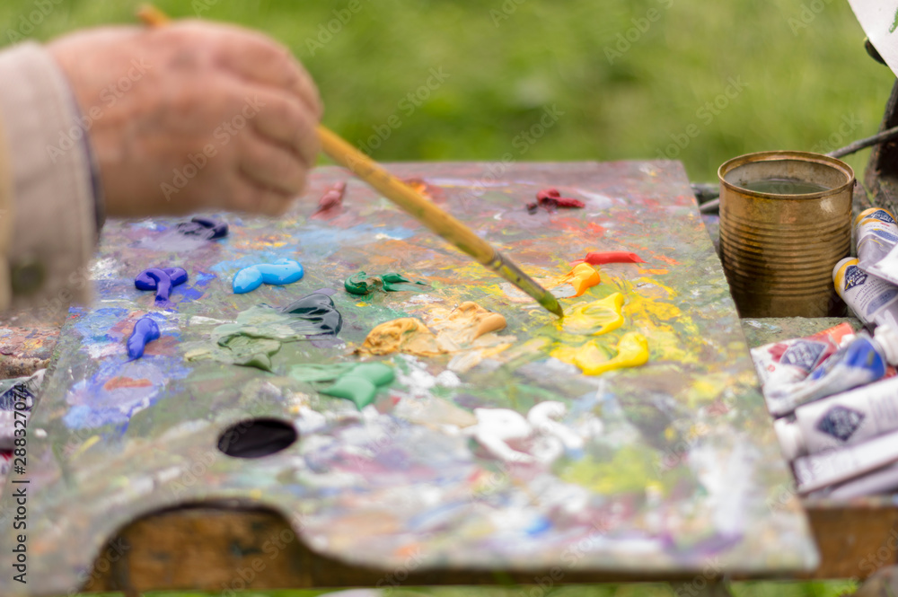 Drawing with oil paints on the nature. Wonderful hobby Drawing with oil paints on the nature. Wonderful hobby