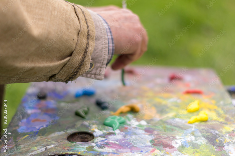 Drawing with oil paints on the nature. Wonderful hobby Drawing with oil paints on the nature. Wonderful hobby