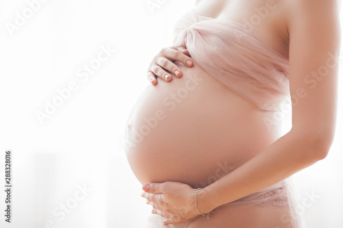 Closeup picture of pegnant woman. Unrecognizable expectant. Belly closeup. photo