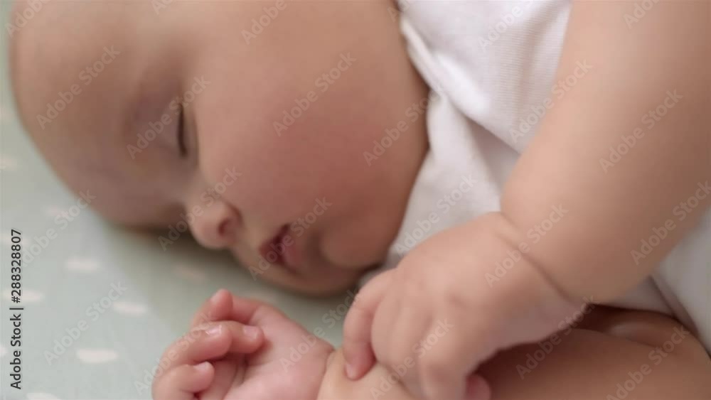 Portrait of cute baby is sleeping on the bed. Close-up. Portrait of cute baby is sleeping on the bed. Close-up.