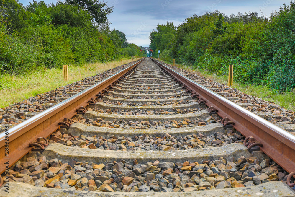 a drone flies in good weather at a very low altitude over railway tracks a drone flies in good weather at a very low altitude over railway tracks