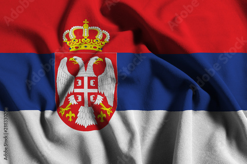 National flag of Serbia on a waving cotton texture background