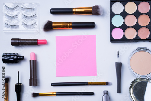 Beauty or cosmetics concept. Creative arrangement of cosmetics on white background. 