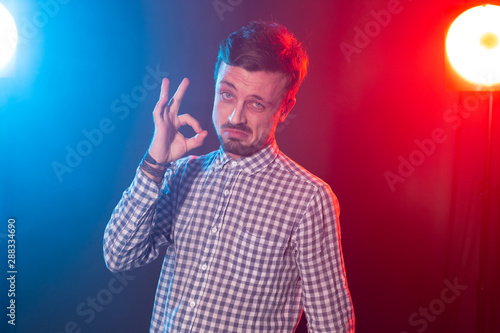 Portrait of young happy smiling attractive man with okay gesture