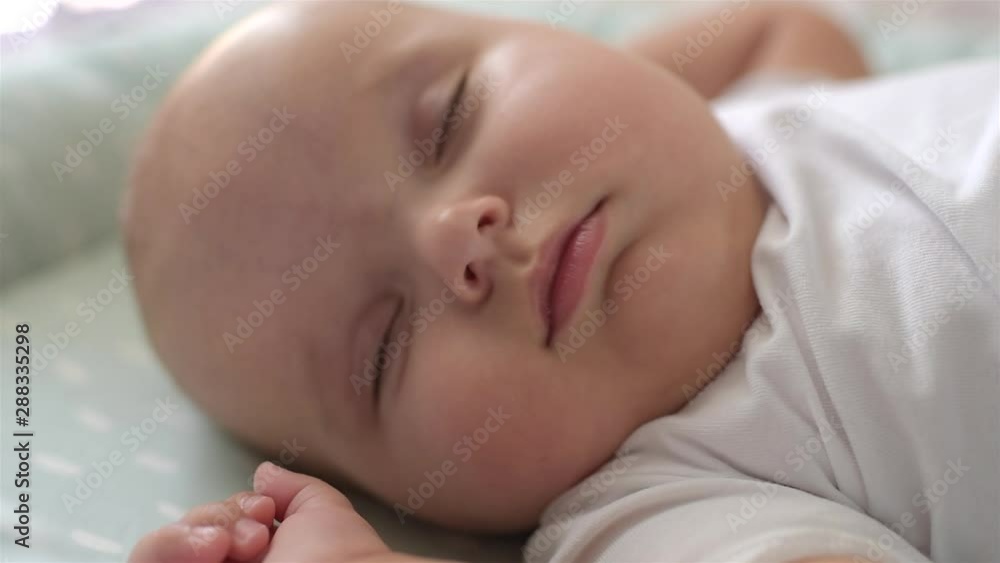 Close-up portrait of a beautiful sleeping baby in bed. Close-up portrait of a beautiful sleeping baby in bed.