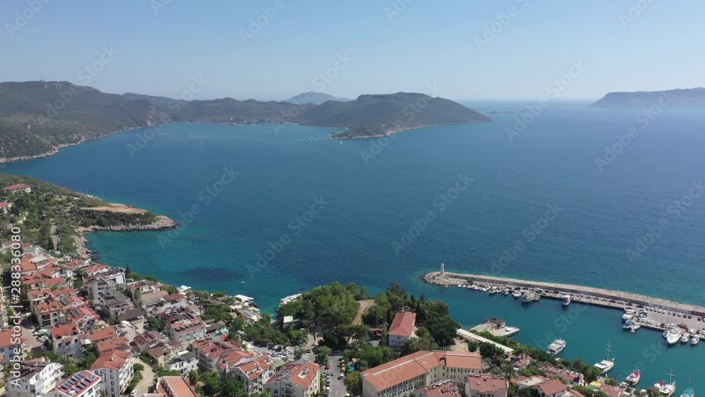 Drone moving towards to the sea aerial view of Kaş / Turkey Town and harbor with beauitful blue sea and sky Drone moving towards to the sea aerial view of Kaş / Turkey Town and harbor with beauitful blue sea and sky