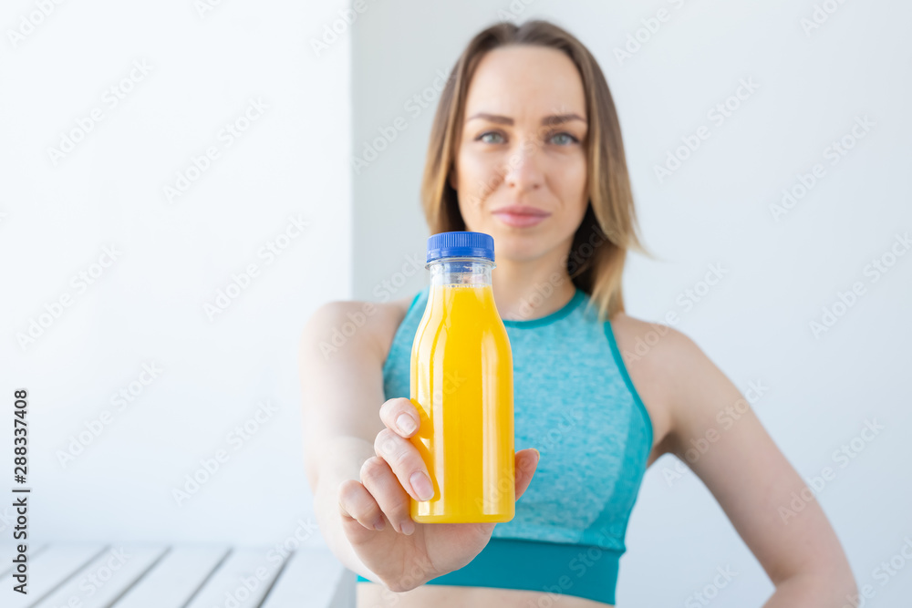 Healthy lifestyle, diet and vitamins - fitness woman with juice close-up Healthy lifestyle, diet and vitamins - fitness woman with juice close-up
