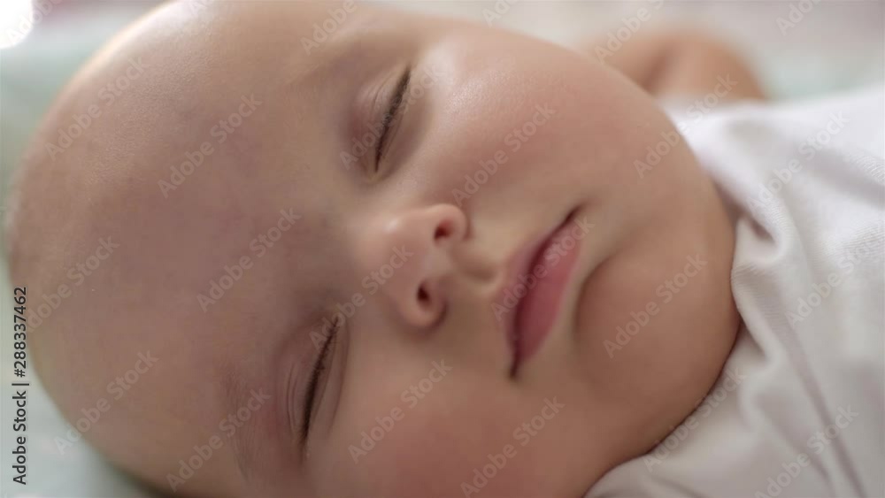 Close-up portrait of a beautiful sleeping baby in bed. Close-up portrait of a beautiful sleeping baby in bed.