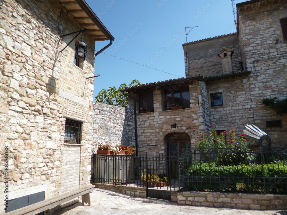 Quiet cozy courtyard on a narrow street of the medieval town of Assisi. Italy, August 2012