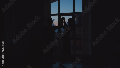 a man and a girl dance, have fun, kiss on a sunset background in the back color