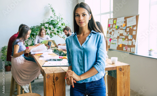 Obraz na plátně Attractive confident modern business woman in casual clothes looks at the camera and smiling