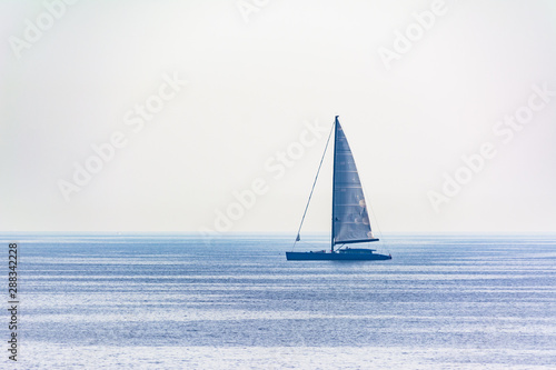 catamaran sailing on the horizon