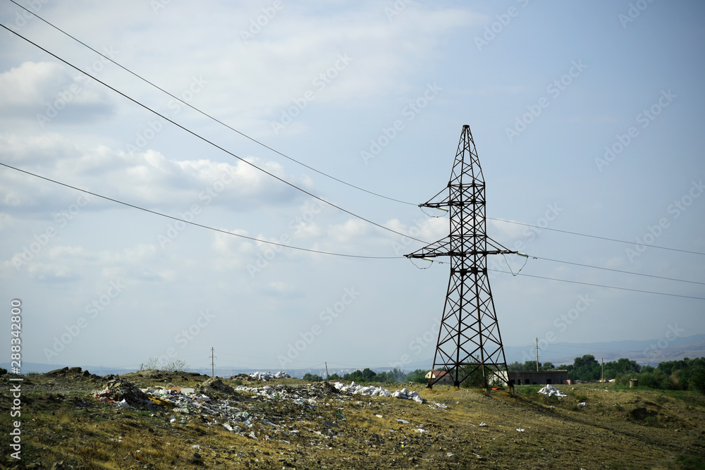Contaminated field in the outskirts of Rustavi. Electricity pole in a polluted area.
