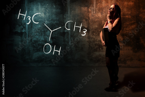 Sexy girl or secretary or female student presenting handdrawn chemical formula of Isopropylalcohol isopropanol 2-propanol photo