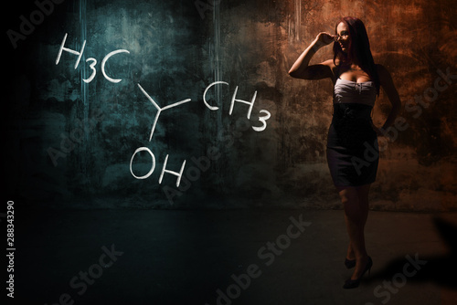 Sexy girl or secretary or female student presenting handdrawn chemical formula of Isopropylalcohol isopropanol 2-propanol photo