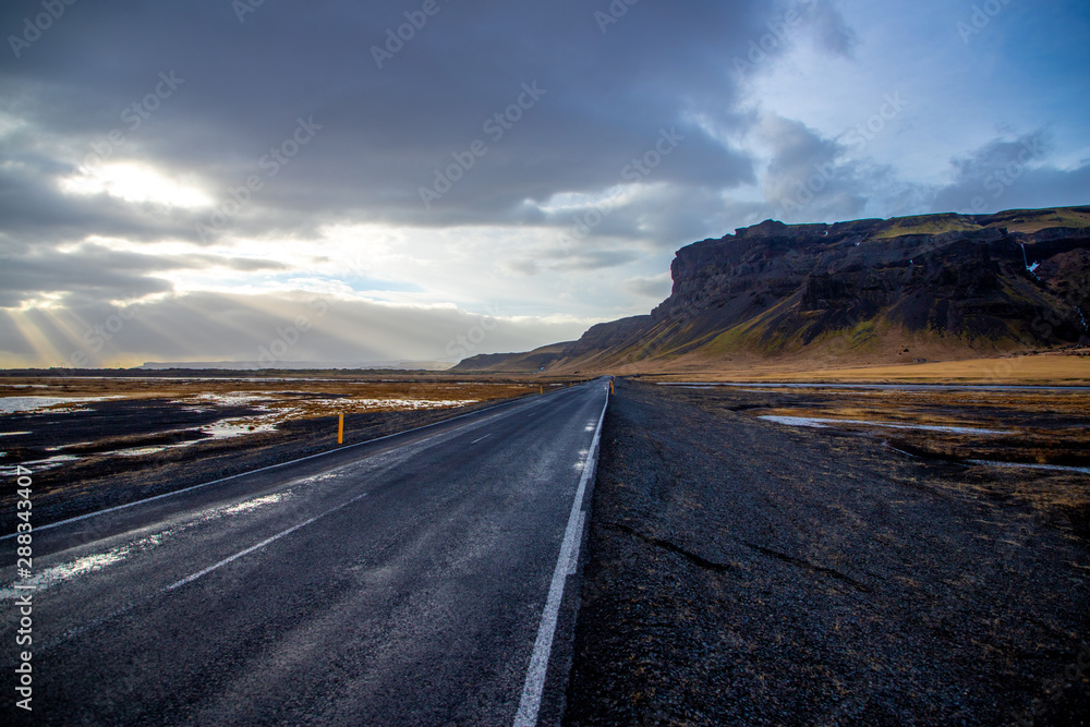 Fototapeta premium Desserted Icelandic road leading to the cliffs