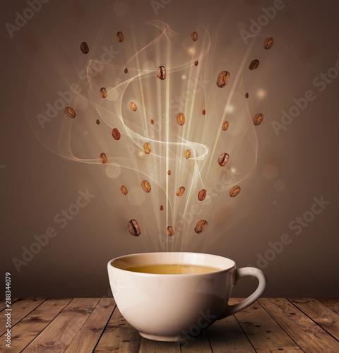 Steaming cup of coffee and coffee beans