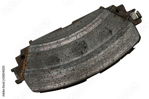 Old brake pads that have been used and worn Was replaced by a caron white background.