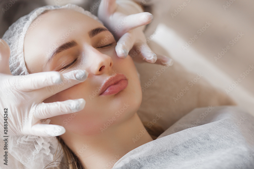 master making a cosmetic procedure for her client. skin care treatment. woman making a face care procedure. master making a cosmetic procedure for her client. skin care treatment. woman making a face care procedure.