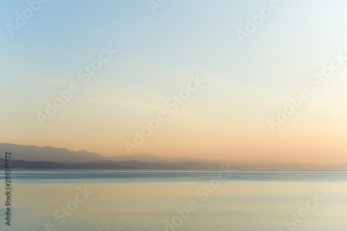 Mountains in the fog  sea and horizon at dawn.