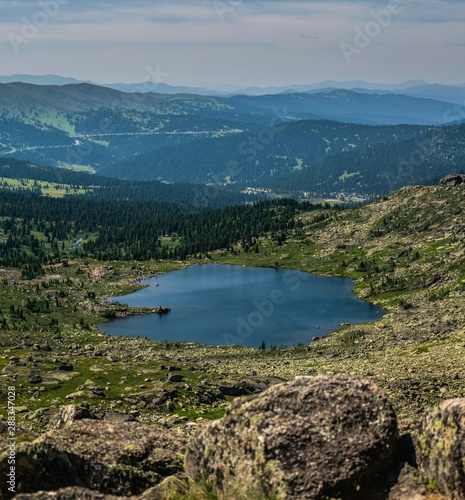 Beautiful view on tarn mountain lake and mointain range in Ergaki national park during summer day, Siberia, Russia