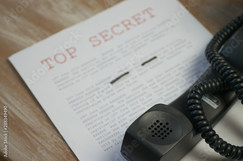 Phone off the hook with top secret document containing classified information 