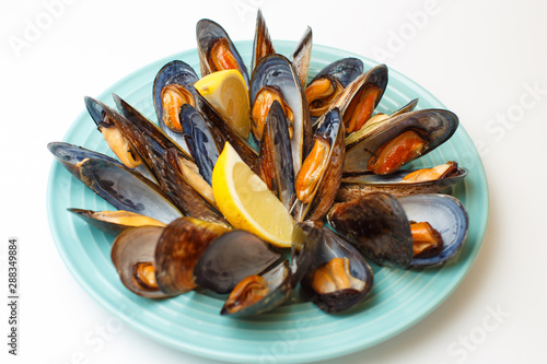 grilled mussels with a sauce on a white background