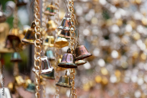 old small bells hanging with small bell blurred background © mr_gateway