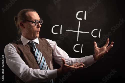 Professor presenting handdrawn chemical formula of carbon tetrachloride photo