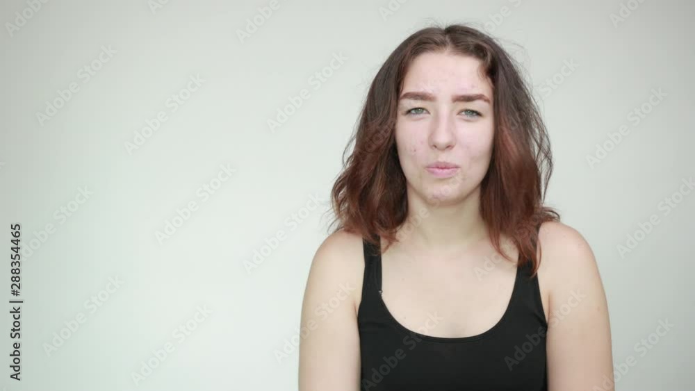 beautiful girl in black tank top over isolated white background shows emotions beautiful girl in black tank top over isolated white background shows emotions