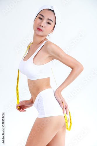 Beautiful woman posing with measure tape © karnstocks