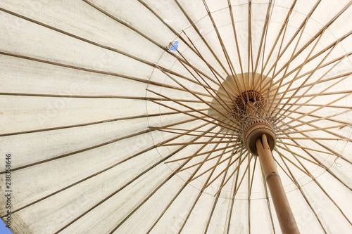 Fototapeta Naklejka Na Ścianę i Meble -  Big bamboo umbrella for outdoors with sky background. Umbrella handmade in the north of Thailand.