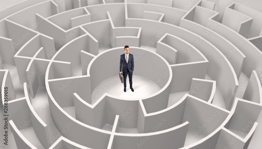 Young businessman standing in a middle of a 3d round maze Young businessman standing in a middle of a 3d round maze