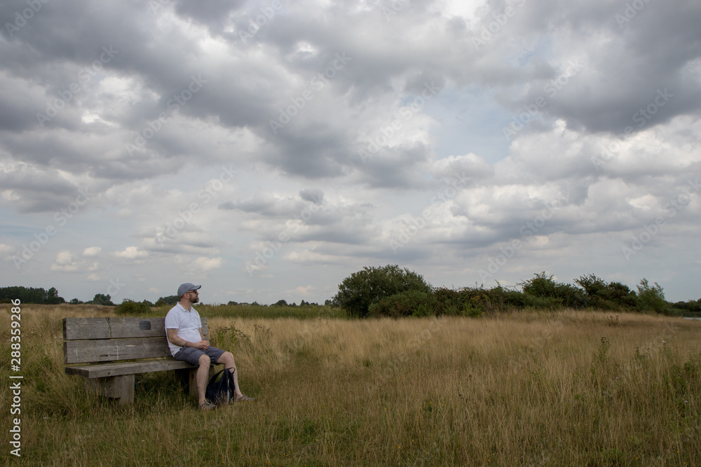 Man on a bench in the park Man on a bench in the park