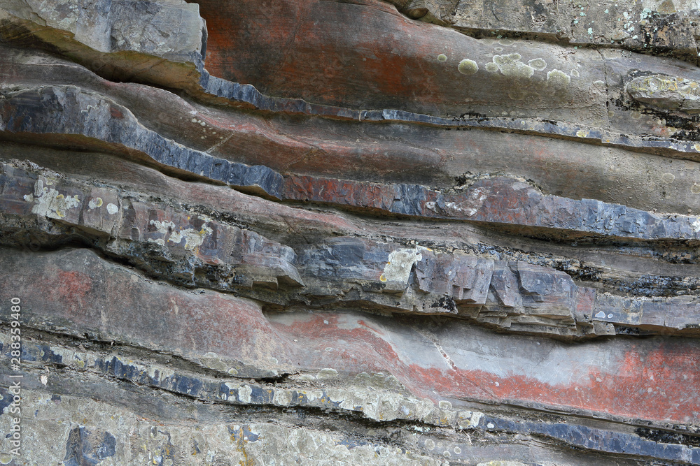 Background on the basis of the texture of rock. Gray-brown-blue layered stone texture Background on the basis of the texture of rock. Gray-brown-blue layered stone texture