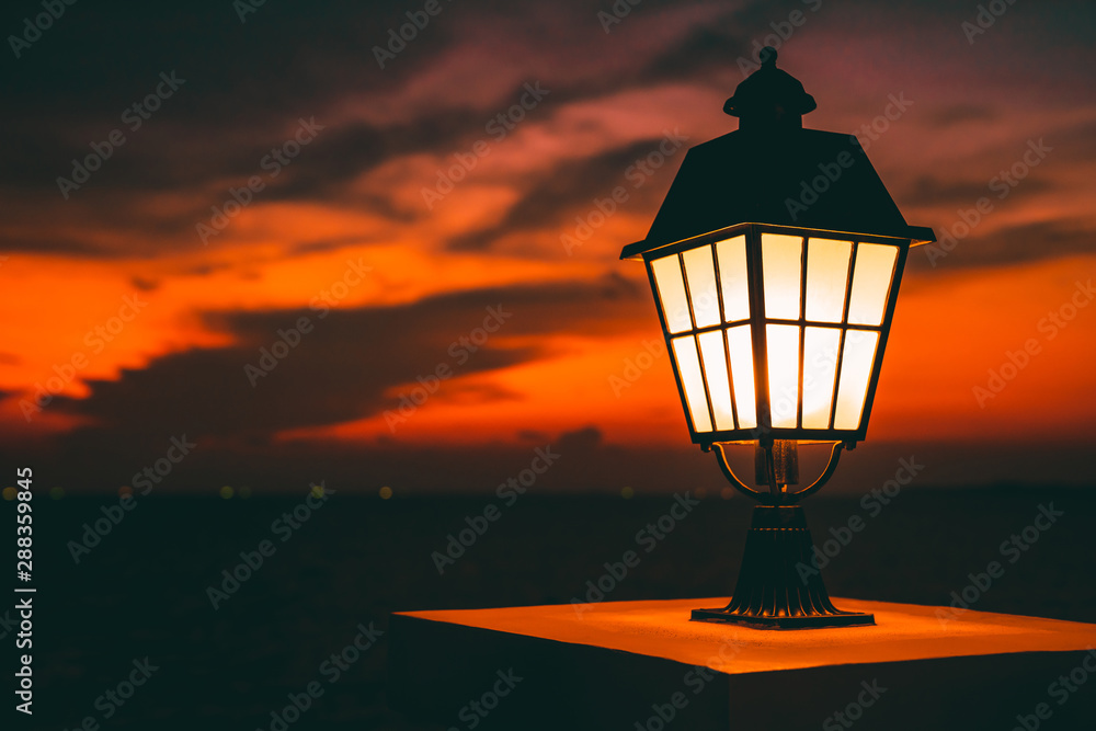 Public classic lights lamp at beach side with landscape view of sunset sky at behinds Public classic lights lamp at beach side with landscape view of sunset sky at behinds